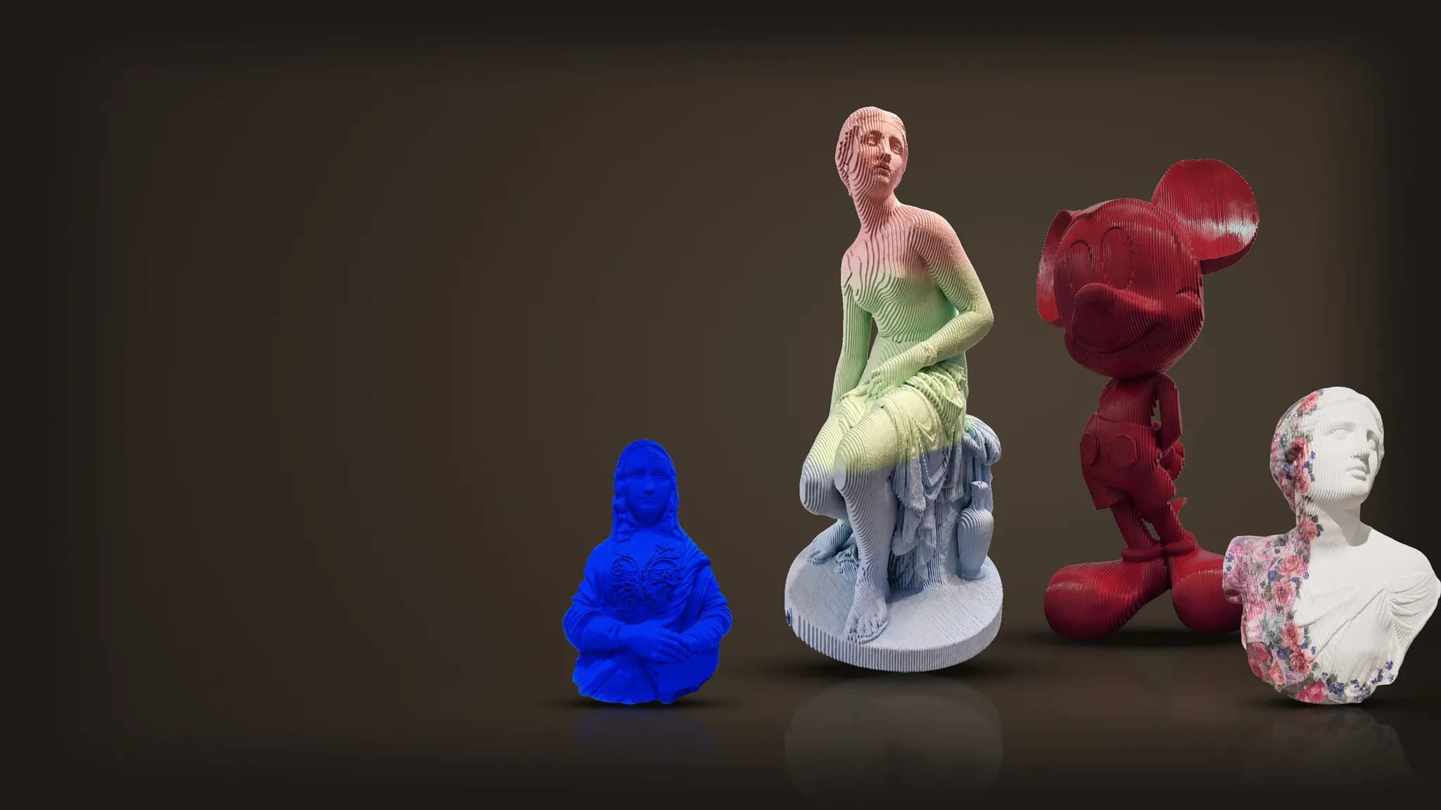 Four sculptures by Daniele Fortuna on a dark stage: Nymph, Mickey, Monalisa and Bust with Flowers