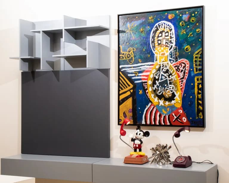 A painting by JAMA hanging above a sideboard in a room
