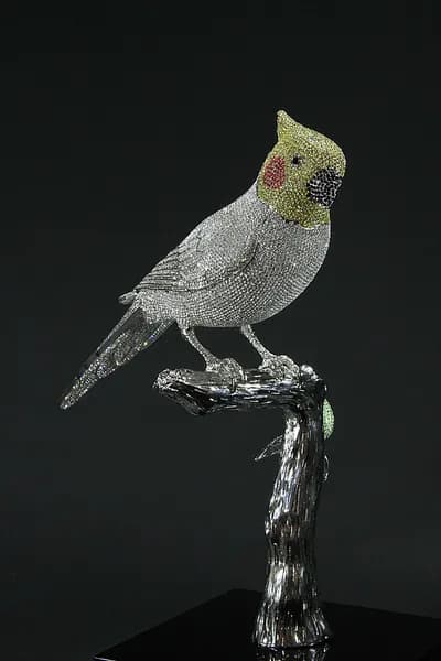 A crystal encrusted cockatiel by Clarita Brinkerhoff on a branch