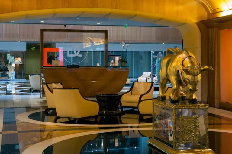 A gilded bull by Apostol on a plinth in a lounge interior