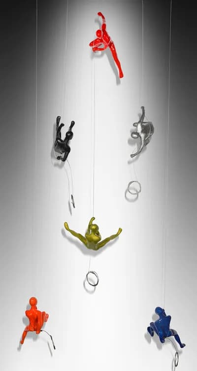 Climbing figures by Ancizar Marin suspended on lines with rings