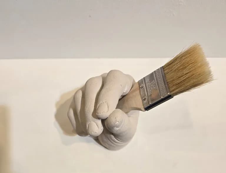 Paul Joseph White, a cast concrete hand holding a paintbrush