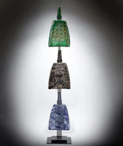 Three sandcast glass forms stacked on a stand by Marlene Rose
