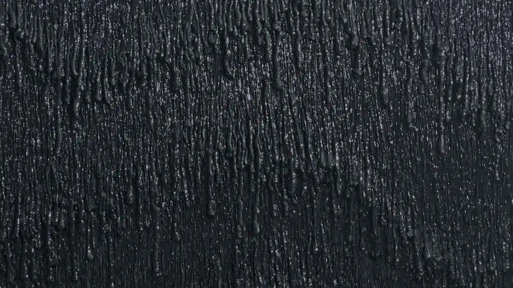 Spill #2, detail: black silicone ridges catching the light on black.